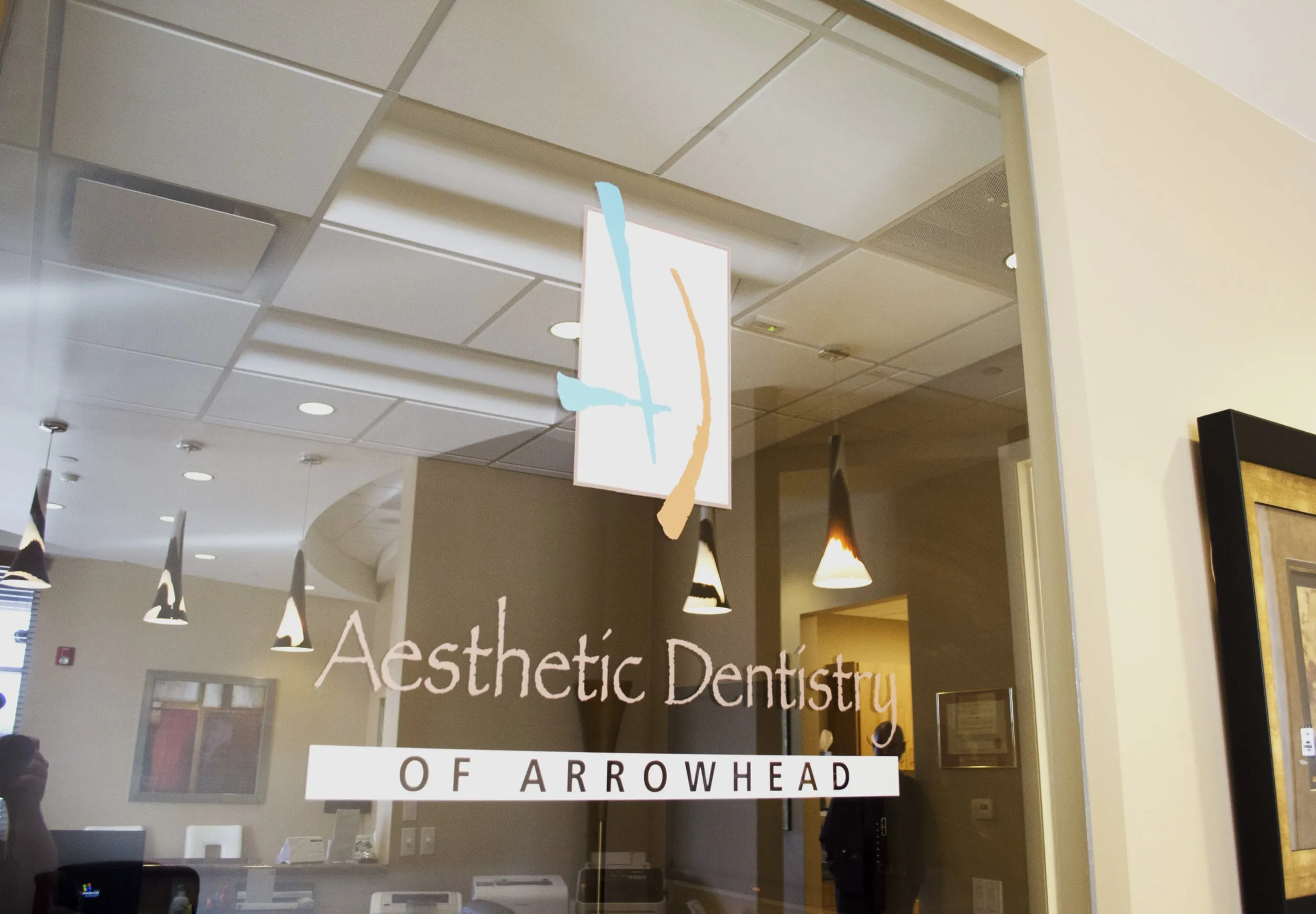 Aesthetic Dentistry of Arrowhead dentist office door logo